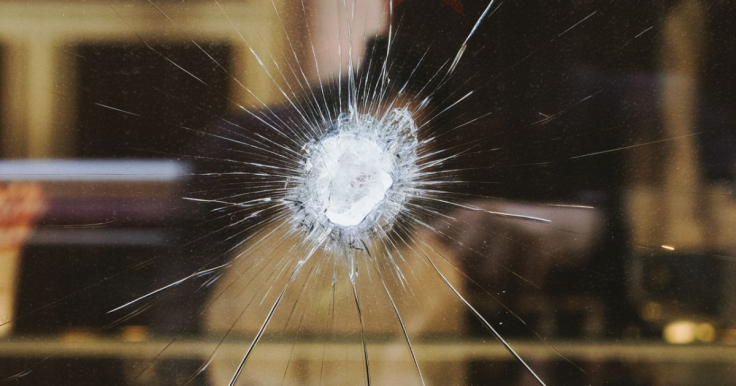 Close-up of a bullet hole on glass