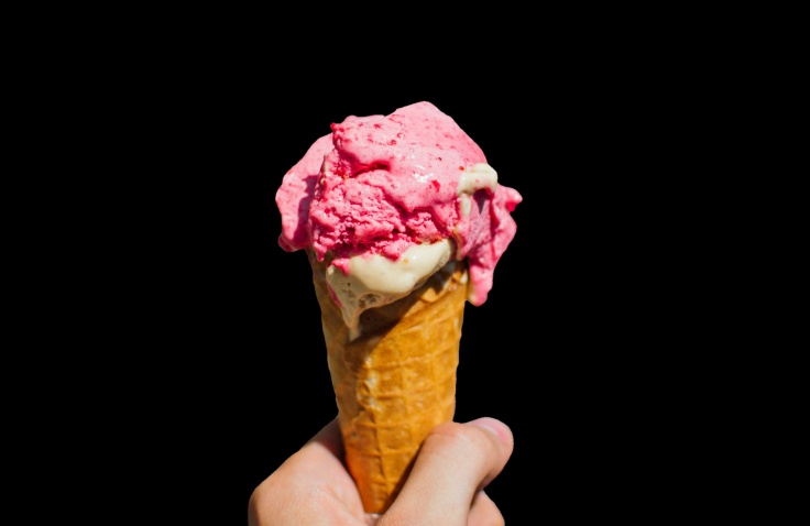 Two-flavored ice cream in a waffle cone.