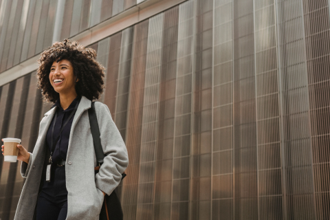 Young professional smiling with coffee cup
