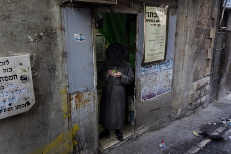 An ultra-Orthodox Jewish man checks an etrog at a market in Jerusalem's Mea Shearim neighbourhood