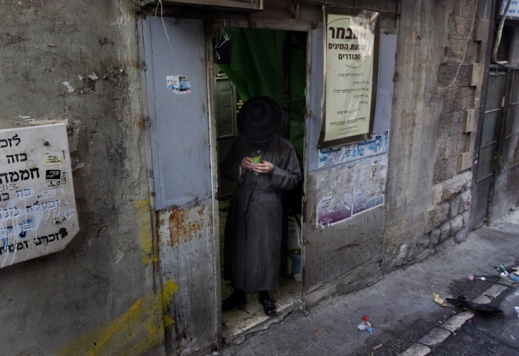 An ultra-Orthodox Jewish man checks an etrog at a market in Jerusalem&#039;s Mea Shearim neighbourhood