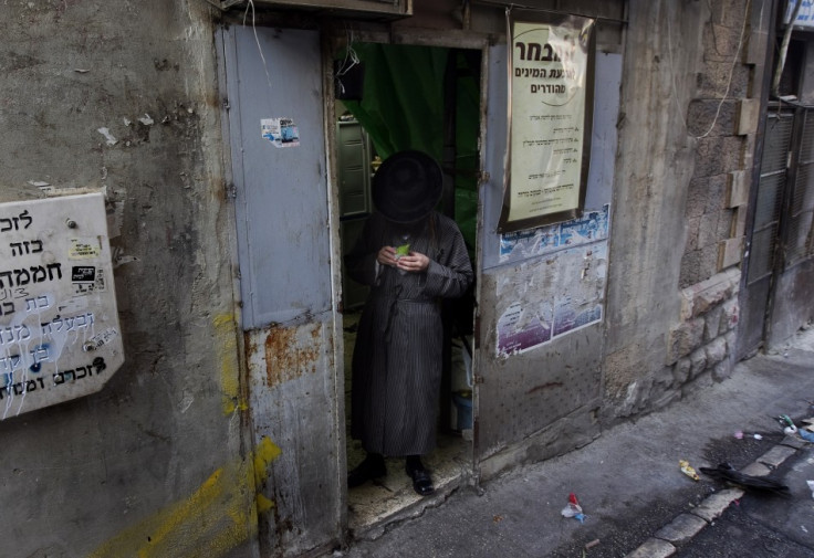 An ultra-Orthodox Jewish man checks an etrog at a market in Jerusalem's Mea Shearim neighbourhood