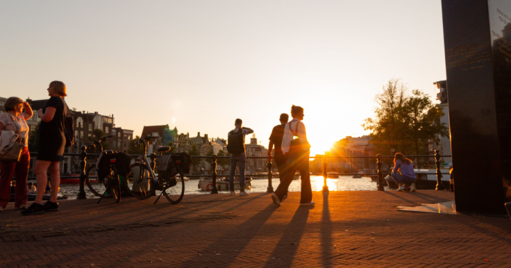 People milling around Amsterdam during sunrise
