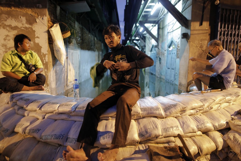 Residents fish from a sandbag barrier built to protect their neighborhood from floods advancing into central Bangkok Residents fish from a sandbag barrier built to protect their neighborhood from floods advancing into central Bangkok