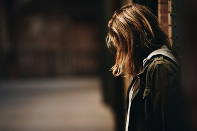 Girl standing in a dim corridor
