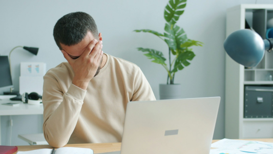 A person sitting at a desk with a laptop