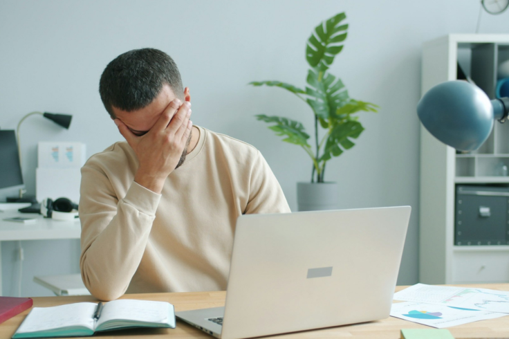 A person sitting at a desk with a laptop