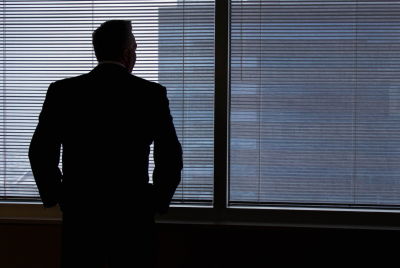 Businessman Silhouette Against Office Windows