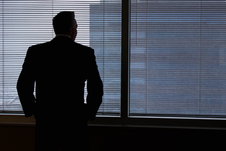 Businessman Silhouette Against Office Windows