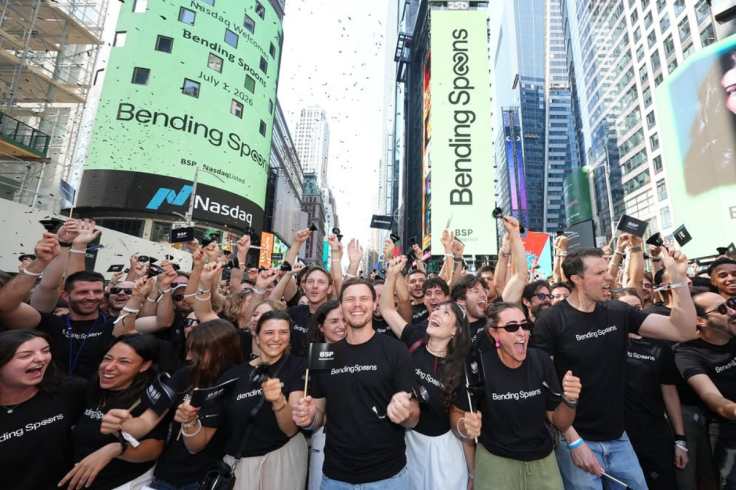 Bending Spoons employees in branded T-shirts cheer in Times Square