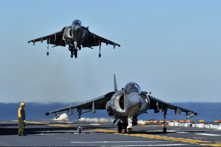 Two Harrier jets on the flight deck of a US