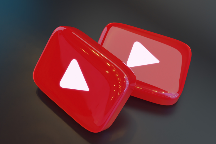 Two red YouTube play buttons on a dark background