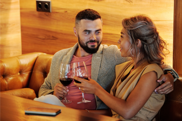 A couple enjoys a romantic evening with wine