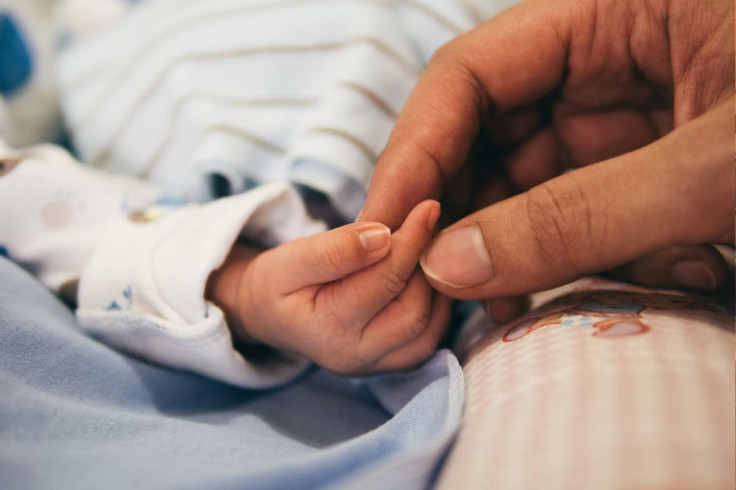 Holding baby’s hand