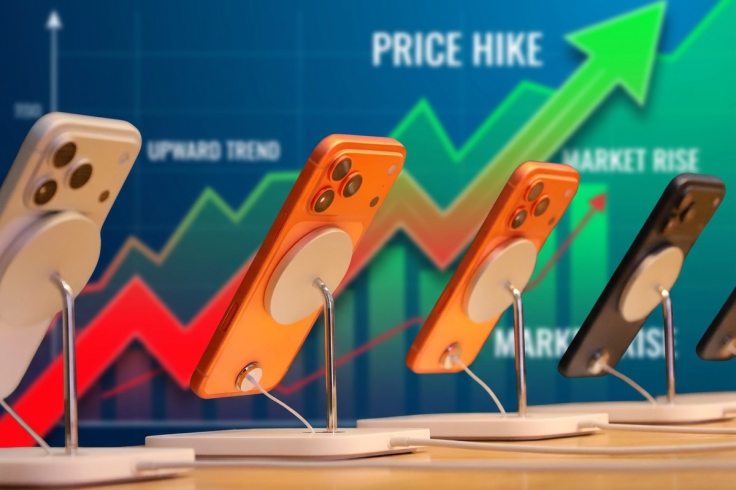 iPhones on display stands against a rising chart