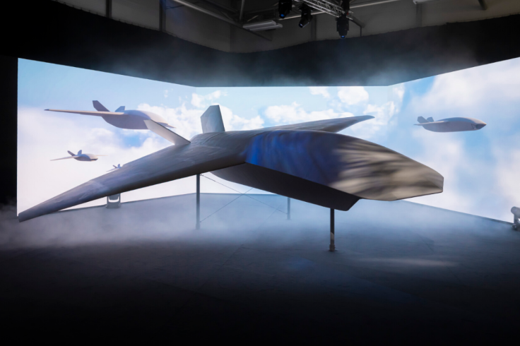 Blended-wing aircraft model displayed in immersive projection studio with cloud