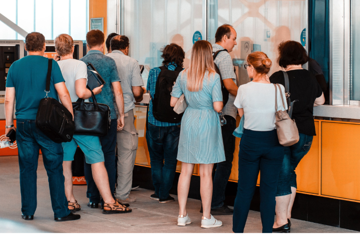People queuing at service desk for pension or benefits claims
