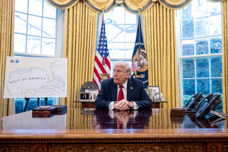 Donald Trump sits at the Resolute desk in the Oval