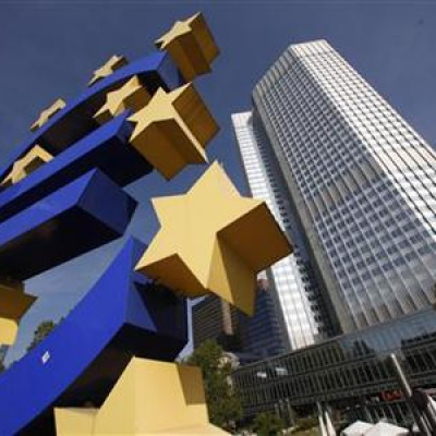 A huge Euro logo is pictured past the headquarters of the European Central Bank (ECB) in Frankfurt
