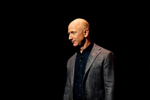 Jeff Bezos in a suit with a dark background.