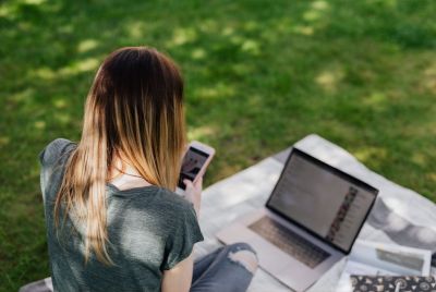 teenage-girl-using-mobile-phone-and-laptop
