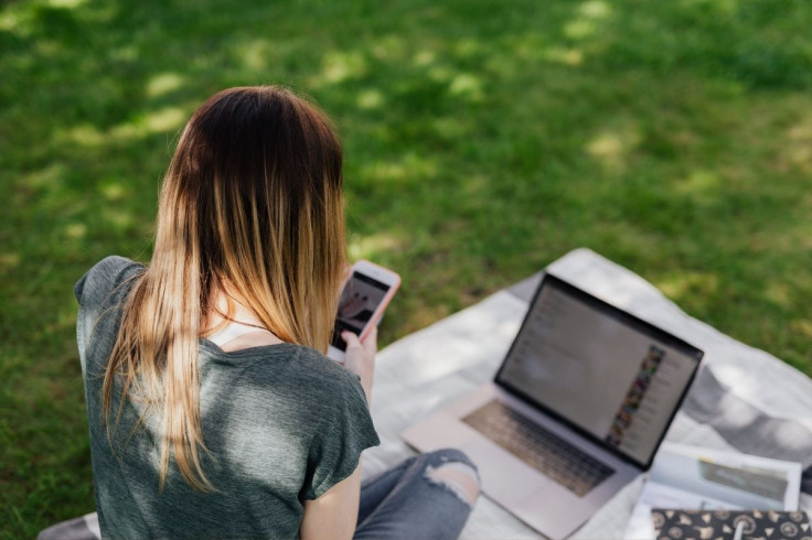 teenage-girl-using-mobile-phone-and-laptop