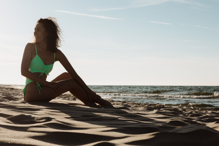 Young woman in a green swimsuit