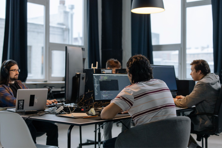 Team of developers working together on computers