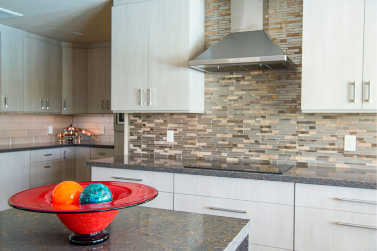 Sleek kitchen design featuring a red bowl with decorative accents