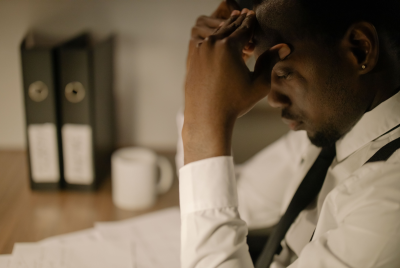 Side view of a stressed businessman in white shirt