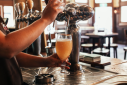 Bartender skillfully pouring a fresh draft beer