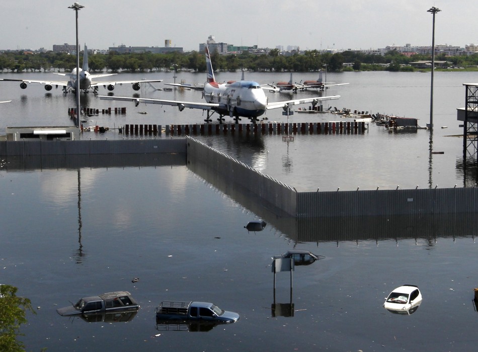 Airplanes are seen parked on the flooded tarmac at Don Muang airport in Bangkok