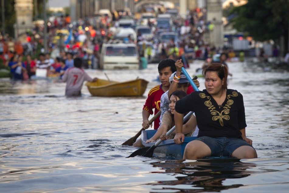 Residents use a boat as transport through a flooded street Bangkoks Bang Phlat district