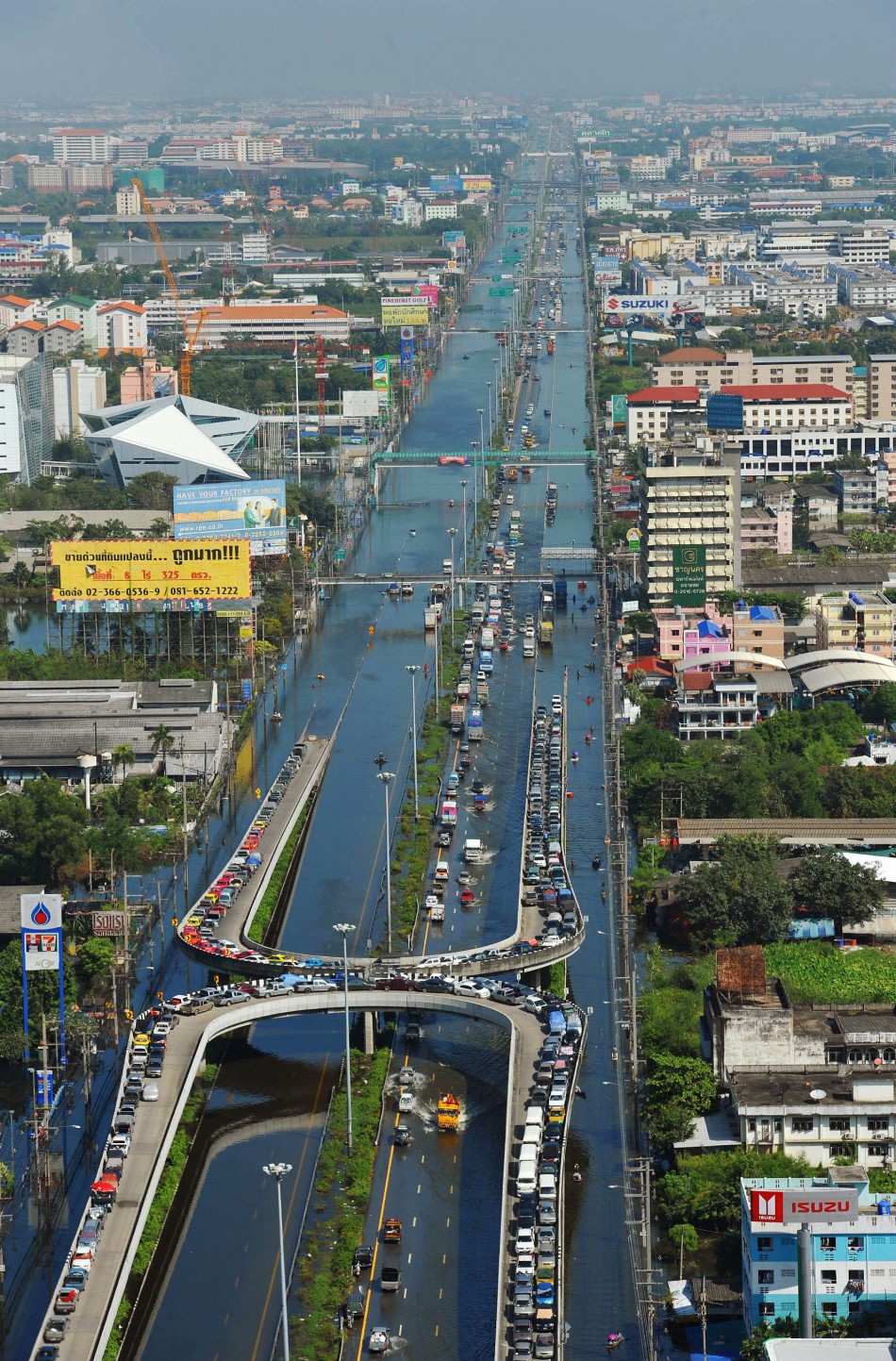 An aerial view shows cars parked on the flyovers to avoid the floodwaters in the northern part of Bangkok