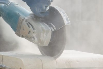 Worker Cutting Quartz Countertop With Silica Dust