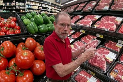 Older Shopper Checks Groceries in Supermarket