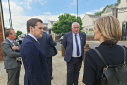 Robert Jenrick speaks with colleagues outside a building.