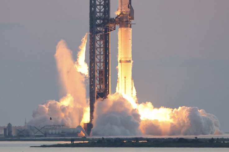 A SpaceX Starship rising from its launch tower
