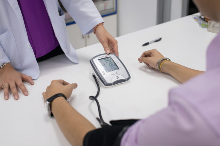 Pharmacist Checking Blood Pressure During Cholesterol Screening