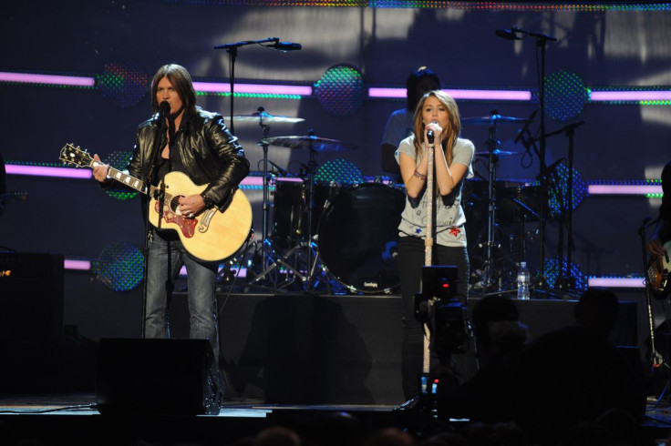 Miley and Billy Cyrus performing on stage in 2009