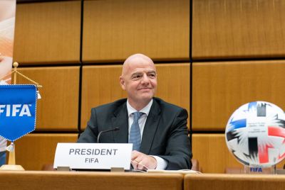 Gianni Infantino sitting, looking ahead, during a FIFA press event
