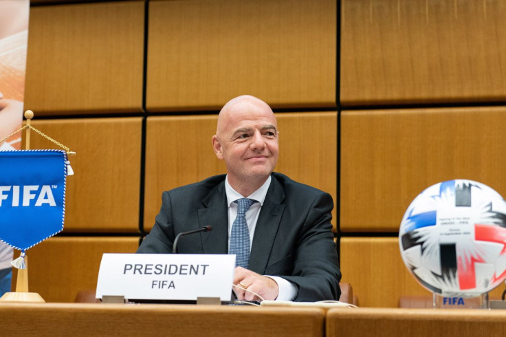 Gianni Infantino sitting, looking ahead, during a FIFA press event