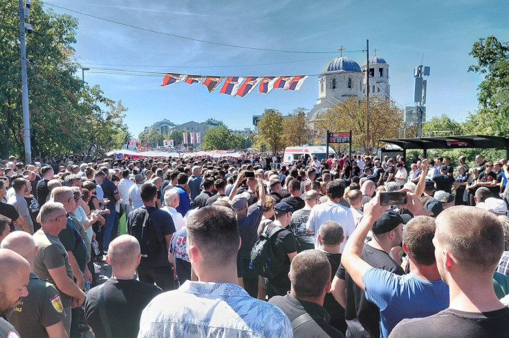 crowd surrounding a funeral procession