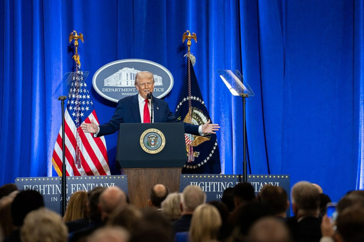 Trump in front of the DOJ and American flags