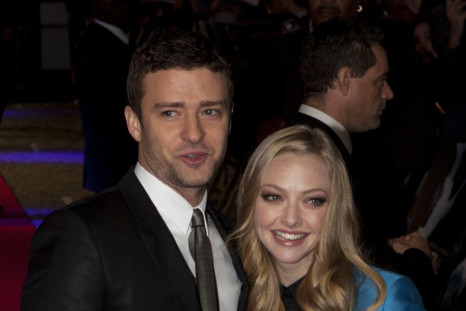 Justin Timberlake (L) and Amanda Seyfried pose for photographers at the British premiere of the film "In Time" at the Curzon Mayfair cinema in London October 31, 2011