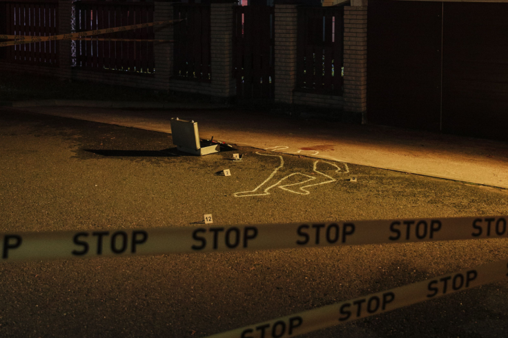 A crime scene at night with chalk outline