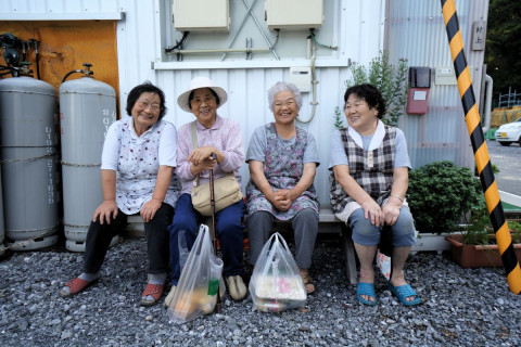 Japanese women sitting on a bench