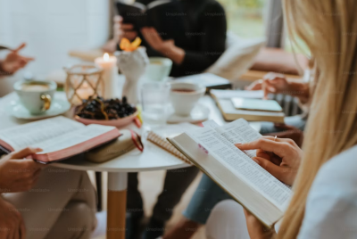 A group of people sitting around a table with books
