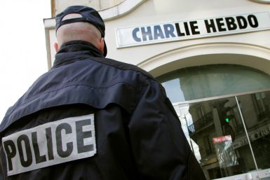 Policeman stands guard outside French satirical weekly &quot;Charlie Hebdo&quot; in Paris after it published controversial cartoons