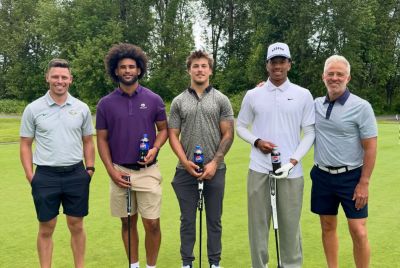 Dante Moore With Teammates in a Golf Event